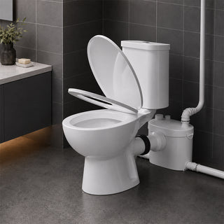 Upflush toilet with a soft close lid in a bathroom setting