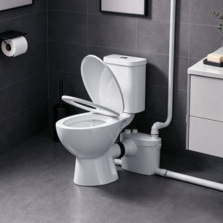 Macerating toilet system with open lid in a bathroom setting